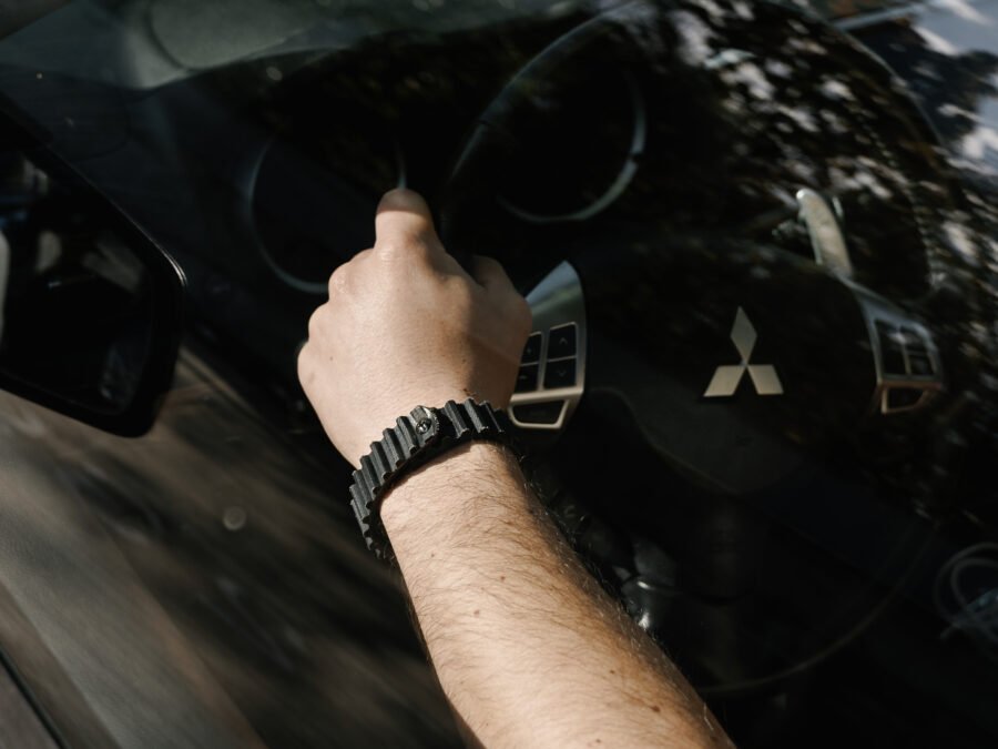 Driver's hand on steering wheel