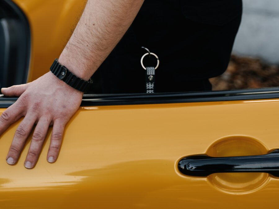 Yellow car door with hand