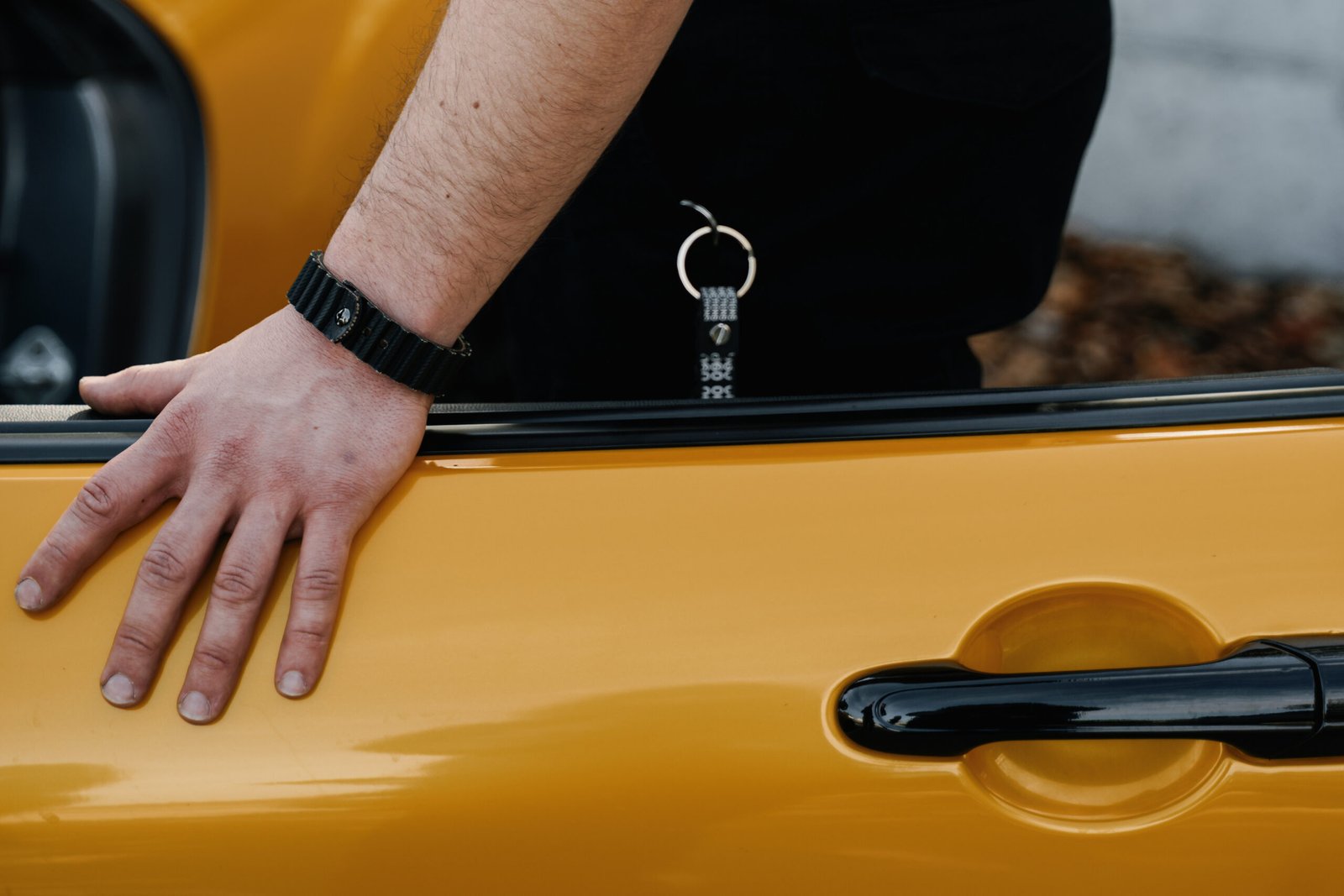 belt2belt Yellow car door with hand